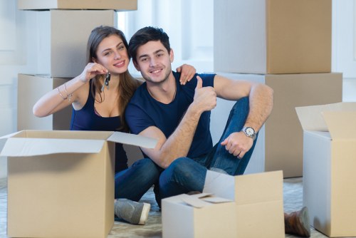 Professional movers carrying furniture during a Thamesmead relocation